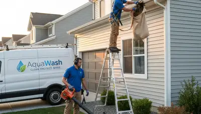 Technician cleaning house gutters and vinyl siding in Medford, MA for Next Level Exteriors